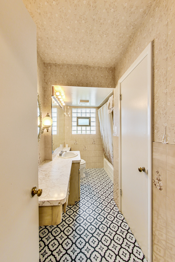 1604 Oakton Street Park Ridge, IL 60068 - Photo 17 of 23 a bathroom with a sink toilet and shower