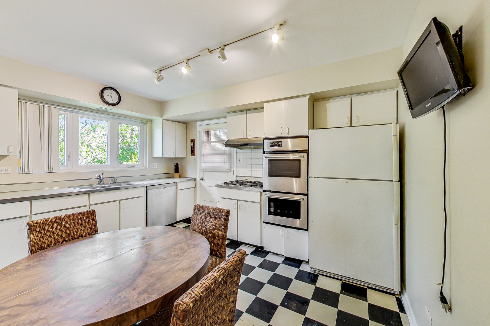 1604 Oakton Street Park Ridge, IL 60068 - Photo 6 of 23 a kitchen with a refrigerator a stove a sink a dining table and chairs