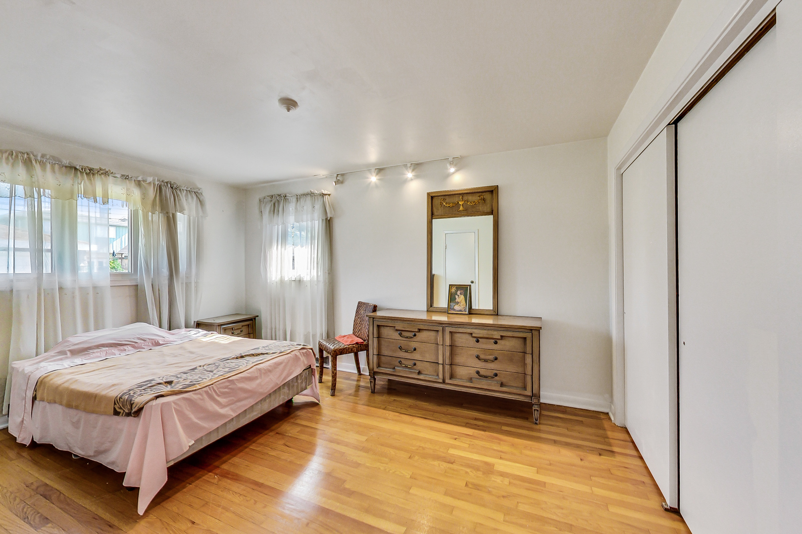 1604 Oakton Street Park Ridge, IL 60068 - Photo 10 of 23 a spacious bedroom with a bed and a dresser