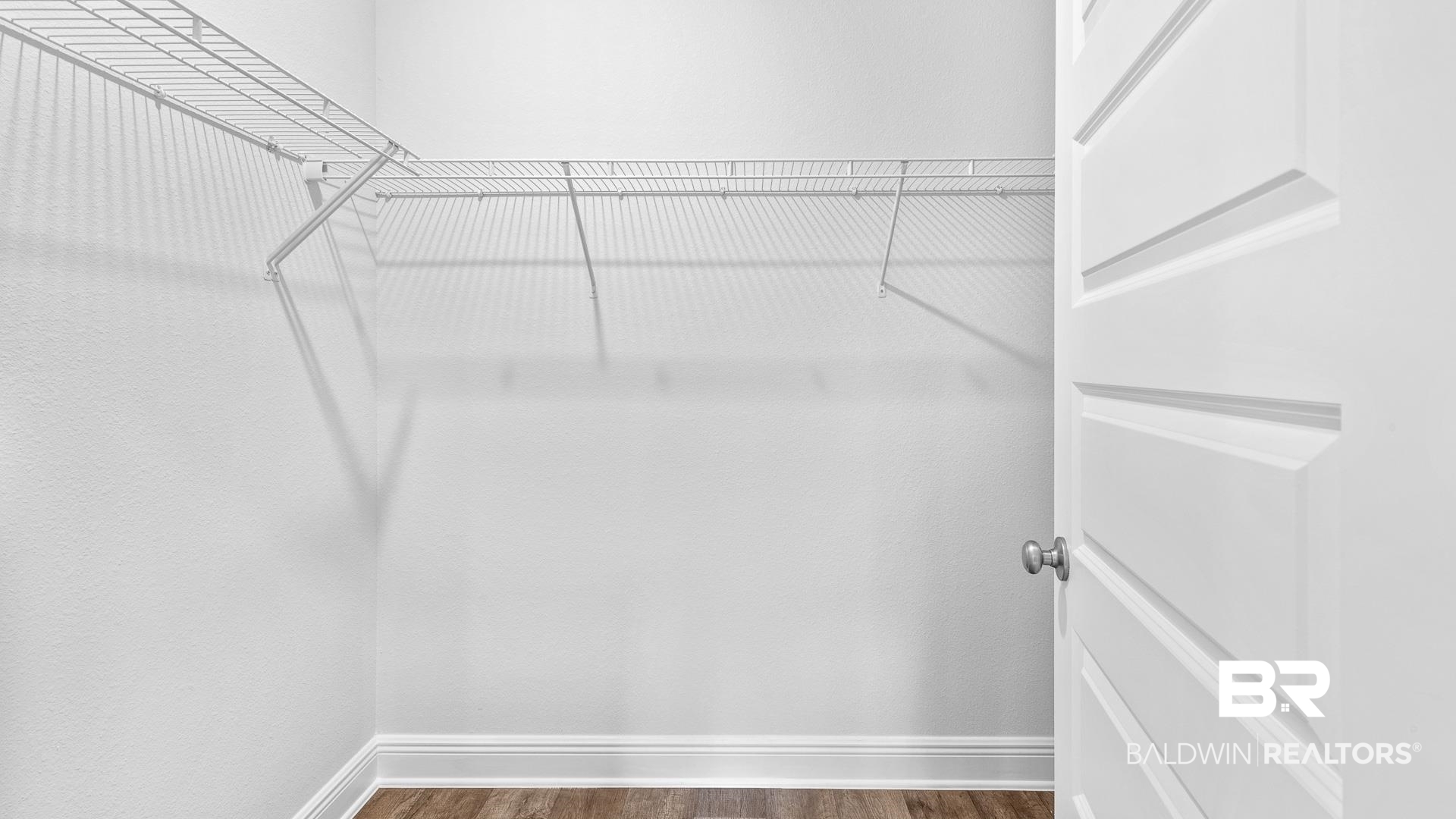 13356 Shea Circle Foley, AL 36535 - Photo 9 of 15 Walk-in closet featuring white wire shelving, wood-finish flooring, and crisp white baseboards