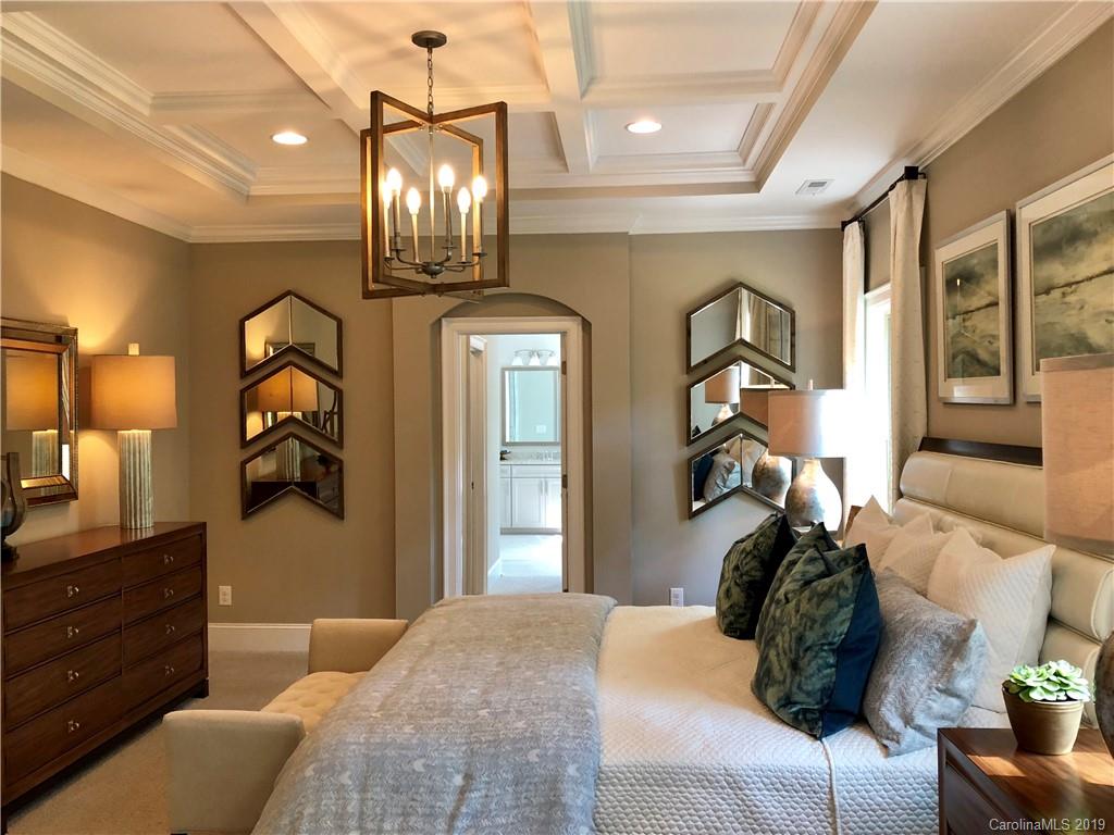 1392 Afton Way, Unit 147 Fort Mill, SC 29708 - Photo 17 of 28 a bedroom with a bed and dresser with mirror