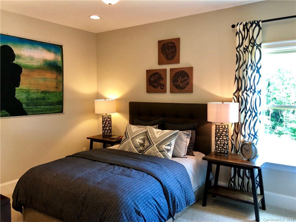 1392 Afton Way, Unit 147 Fort Mill, SC 29708 - Photo 21 of 28 a bedroom with a bed and a painting on the wall