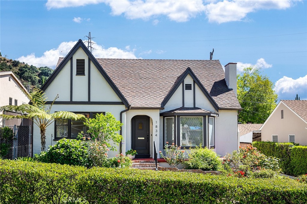 a view of a house with brick walls and potted plants