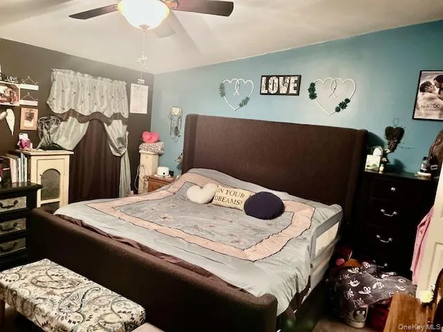 a bedroom with a bed and a chair