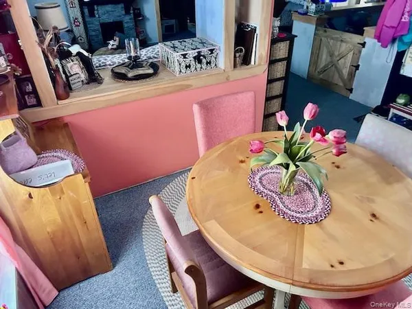 a dining room with furniture and wooden floor