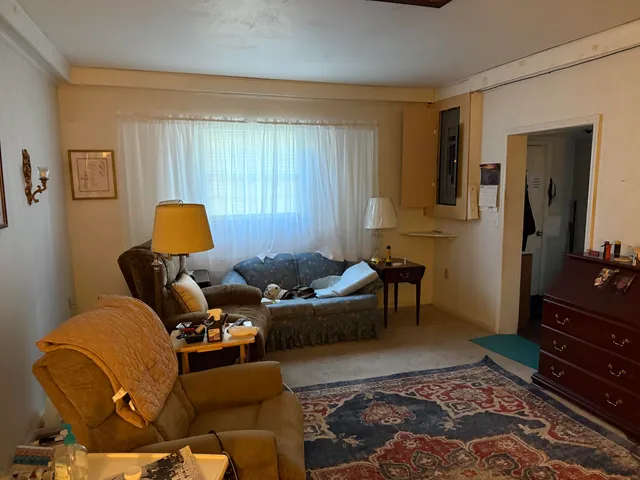 a living room with furniture and a dresser