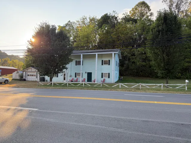 a view of a house with a backyard and a trees