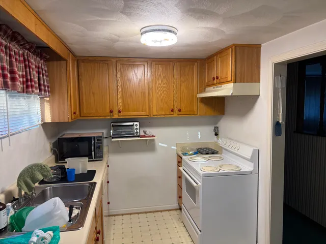 a kitchen with a sink cabinets and appliances