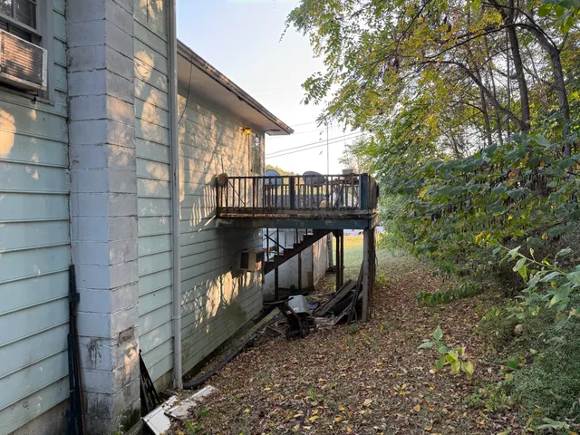 a view of a balcony with wooden fence and floor