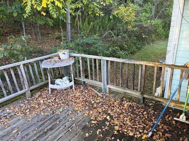 a balcony with wooden floor and fence