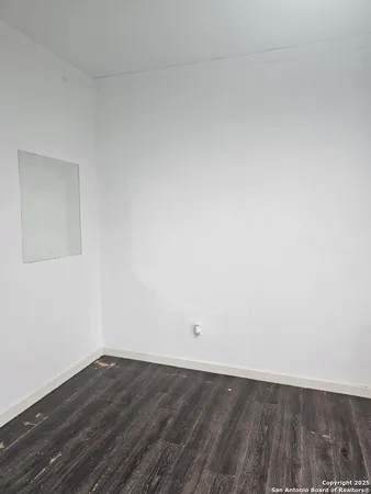 a view of an empty room and wooden floor