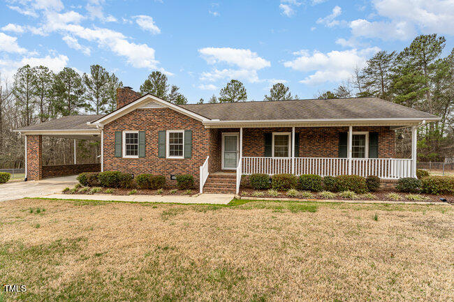6693 Silk Hope Liberty Road Siler City, NC 27344 - Photo 1 of 32 a front view of a house with a yard
