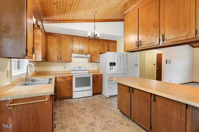 6693 Silk Hope Liberty Road Siler City, NC 27344 - Photo 12 of 32 a kitchen with a sink stove and cabinets