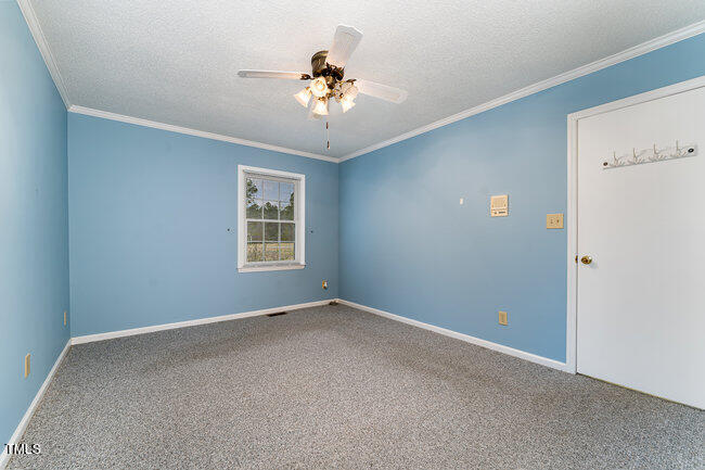 6693 Silk Hope Liberty Road Siler City, NC 27344 - Photo 15 of 32 a view of an empty room with a window