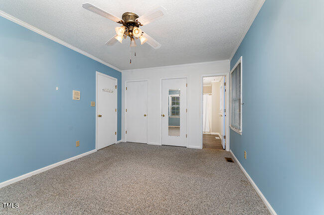6693 Silk Hope Liberty Road Siler City, NC 27344 - Photo 16 of 32 a view of a big room with chandelier fan