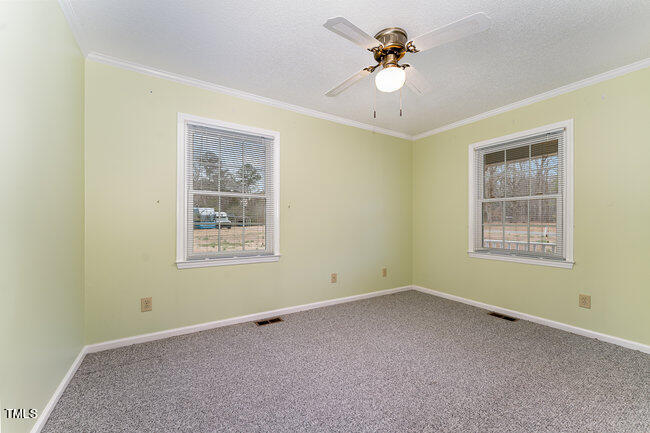 6693 Silk Hope Liberty Road Siler City, NC 27344 - Photo 18 of 32 a view of an empty room with a window