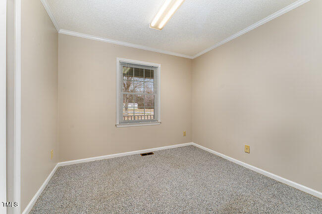 6693 Silk Hope Liberty Road Siler City, NC 27344 - Photo 20 of 32 an empty room with a window