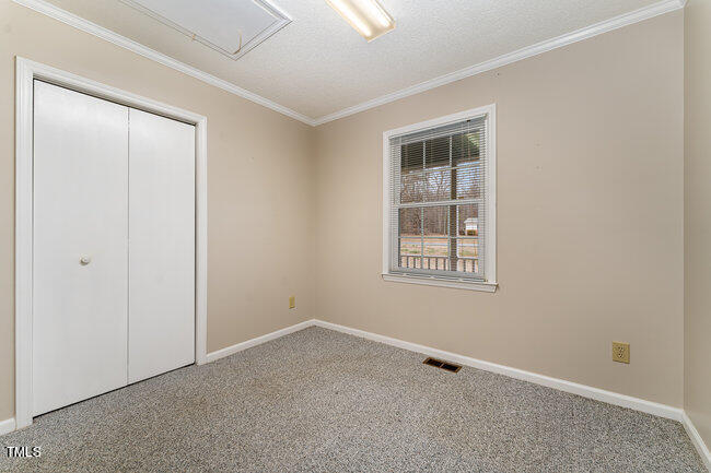 6693 Silk Hope Liberty Road Siler City, NC 27344 - Photo 21 of 32 an empty room with windows