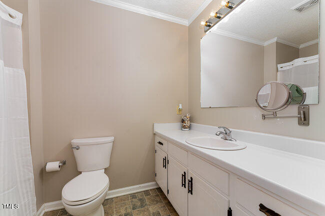 6693 Silk Hope Liberty Road Siler City, NC 27344 - Photo 23 of 32 a bathroom with a toilet sink and mirror