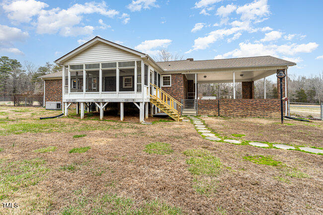6693 Silk Hope Liberty Road Siler City, NC 27344 - Photo 28 of 32 a view of a house with backyard