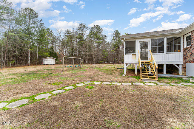 6693 Silk Hope Liberty Road Siler City, NC 27344 - Photo 29 of 32 a house view with a outdoor space