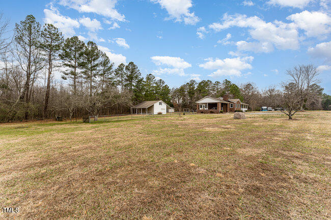 6693 Silk Hope Liberty Road Siler City, NC 27344 - Photo 3 of 32 a view of a field of grass and trees