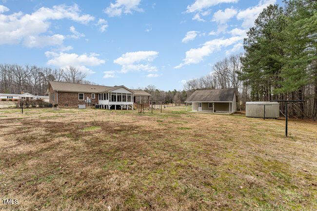 6693 Silk Hope Liberty Road Siler City, NC 27344 - Photo 32 of 32 a view of a house with a yard