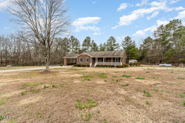 6693 Silk Hope Liberty Road Siler City, NC 27344 - Photo 4 of 32 a house with swimming pool in front of it