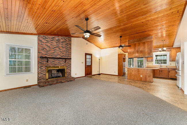 6693 Silk Hope Liberty Road Siler City, NC 27344 - Photo 9 of 32 a view of a livingroom with a fireplace and window