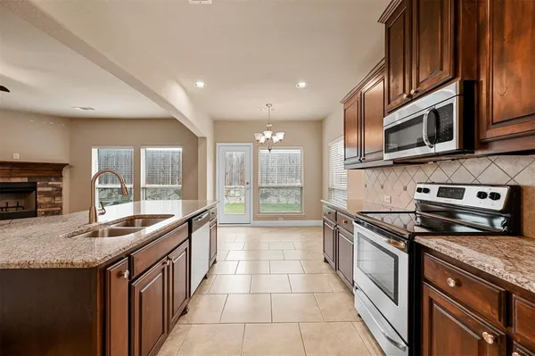 a kitchen with stainless steel appliances granite countertop a stove and a sink
