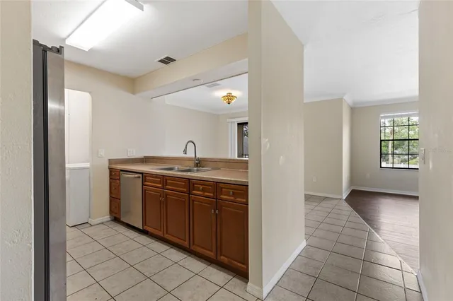 a kitchen with stainless steel appliances granite countertop a sink and cabinets