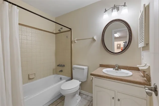 a bathroom with a sink a mirror a toilet and a shower