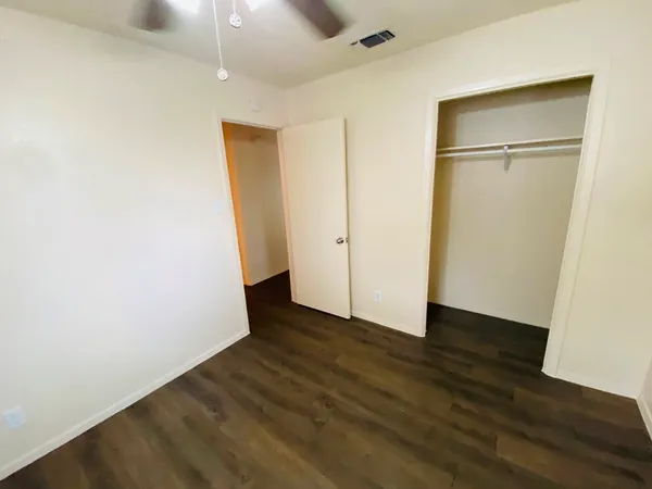 an empty room with wooden floor