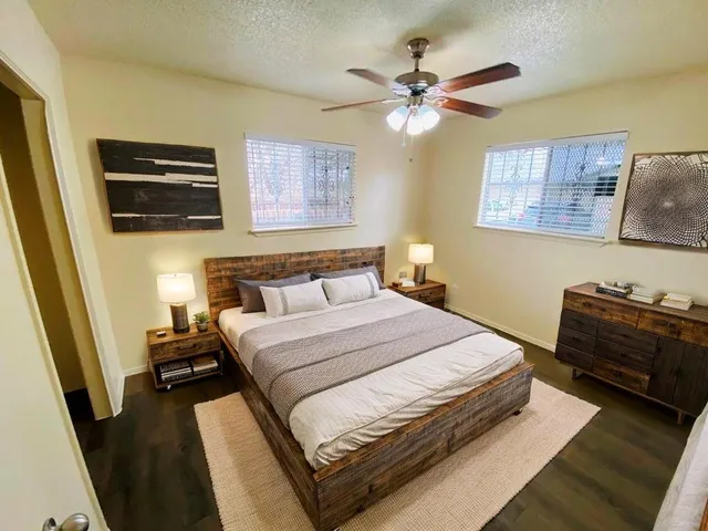 a bedroom with a bed and a flat screen tv