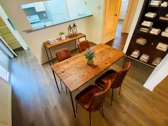 a view of a dining room with furniture and wooden floor