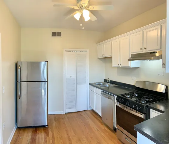 a kitchen with a sink stove and refrigerator