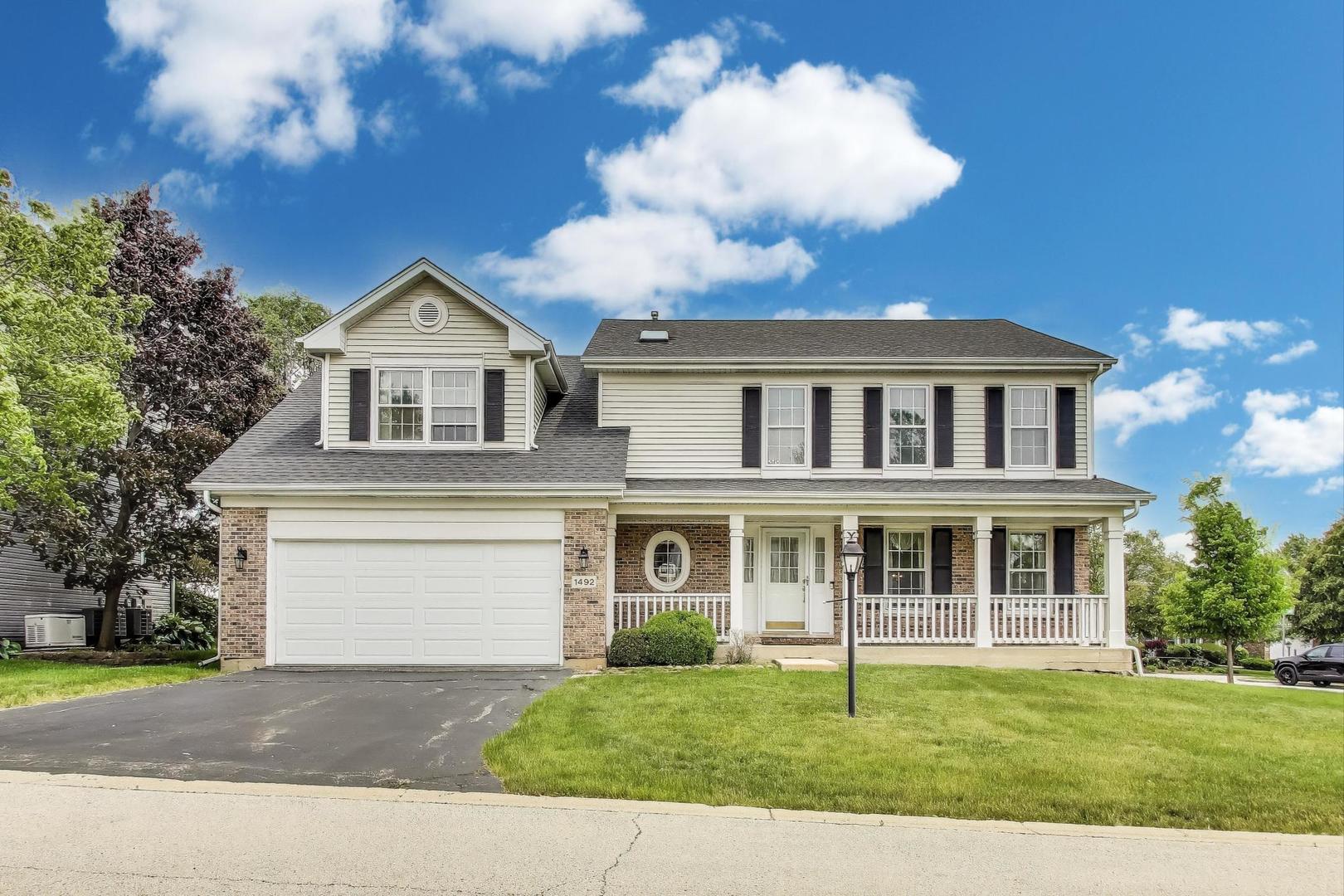 1492 Della Drive Hoffman Estates, IL 60169 - Photo 1 of 1 a front view of a house with a garden and trees