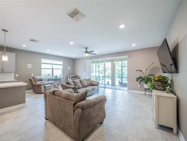 a large kitchen with kitchen island a sink stainless steel appliances and cabinets