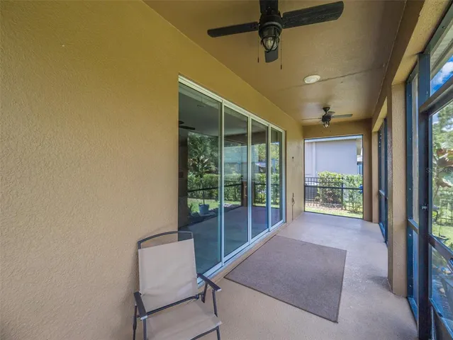 an empty room with closet and a ceiling fan
