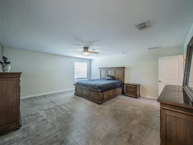 a view of a big room with closet and chandelier fan