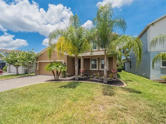a view of a house with a yard and pathway