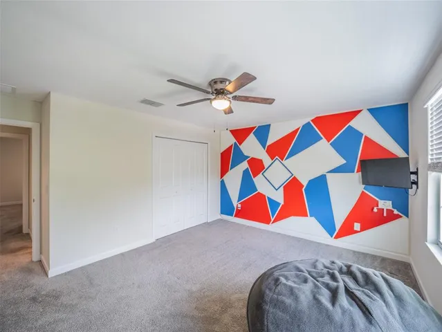 an empty room with windows and refrigerator