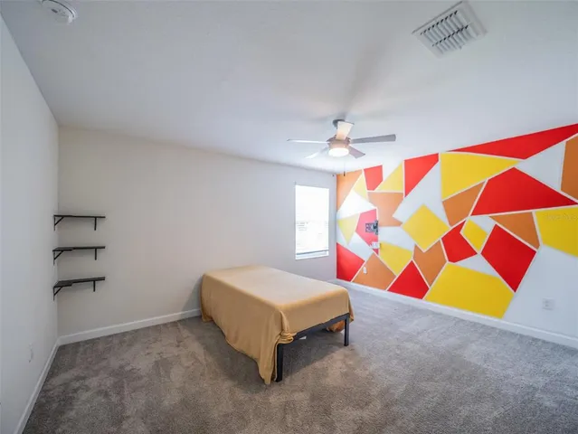 an aerial view of a house with a yard basket ball court and outdoor seating