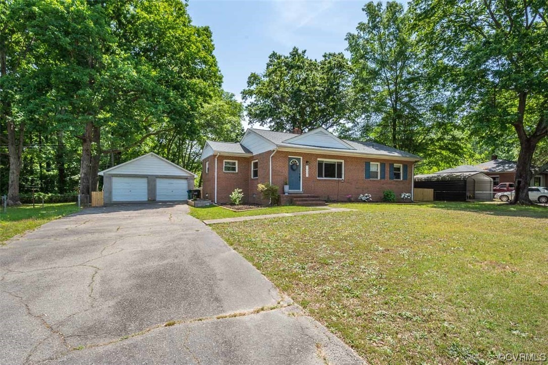 1025 Andros Road Richmond, VA 23225 - Photo 4 of 37 a front view of a house with a garden and tree