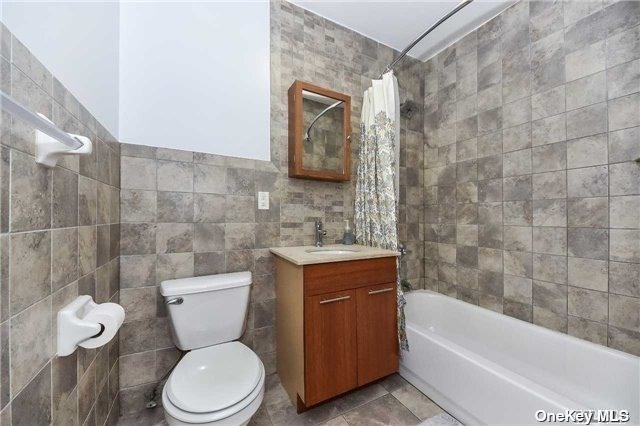 a bathroom with a toilet a sink and bathtub