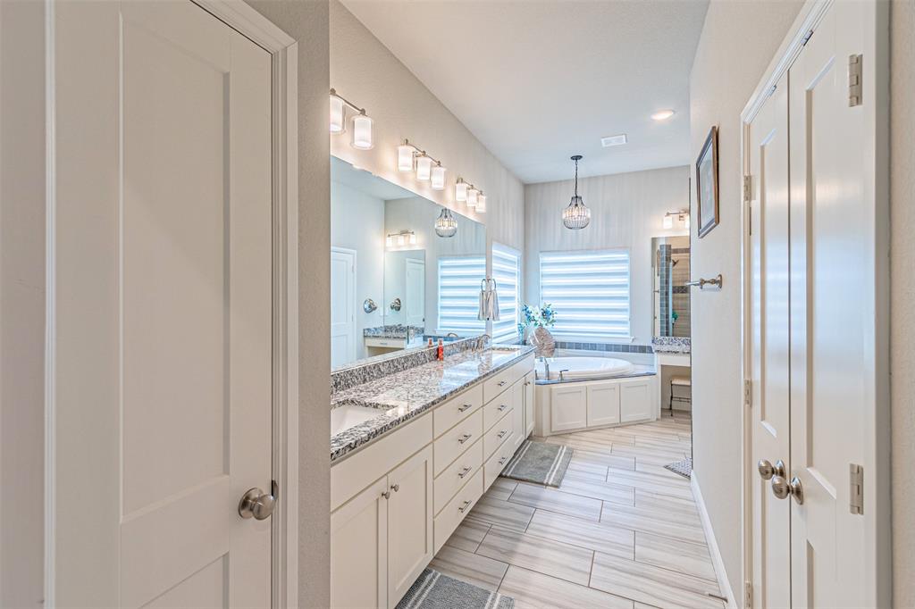 1009 Henry Way Springtown, TX 76082 - Photo 24 of 40 Bathroom featuring double vanity, a bath, wood finish floors, and recessed lighting