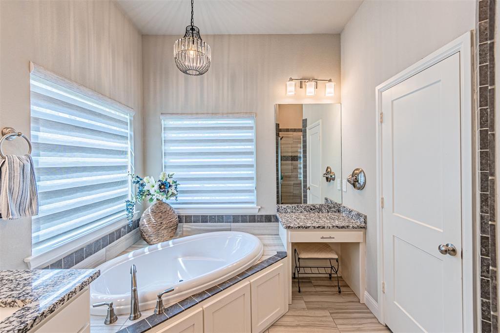 1009 Henry Way Springtown, TX 76082 - Photo 25 of 40 Bathroom featuring a bath, a stall shower, vanity, wood finish floors, and a chandelier