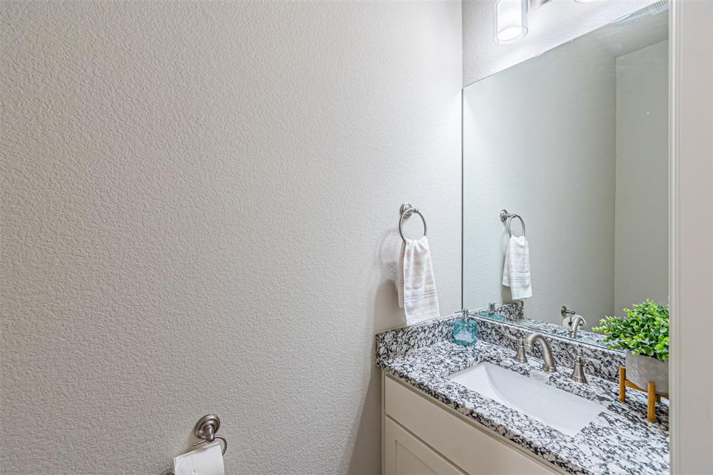 1009 Henry Way Springtown, TX 76082 - Photo 27 of 40 Half bathroom featuring a textured wall and vanity
