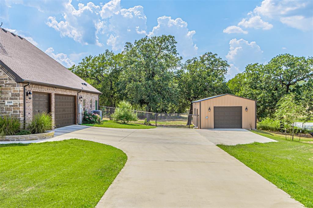 1009 Henry Way Springtown, TX 76082 - Photo 3 of 40 Detached garage with view of scattered trees