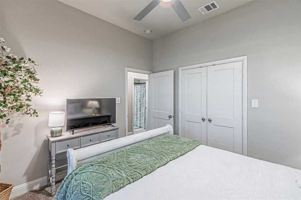 1009 Henry Way Springtown, TX 76082 - Photo 32 of 40 Bedroom with a closet, a ceiling fan, and a textured wall